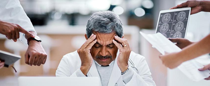 Physician-suffering-from-burnout_-Colleagues-handing-him-materials