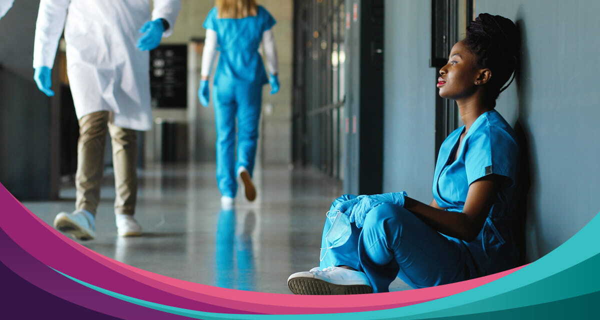 featured-nurse-exhausted-hallway-seated